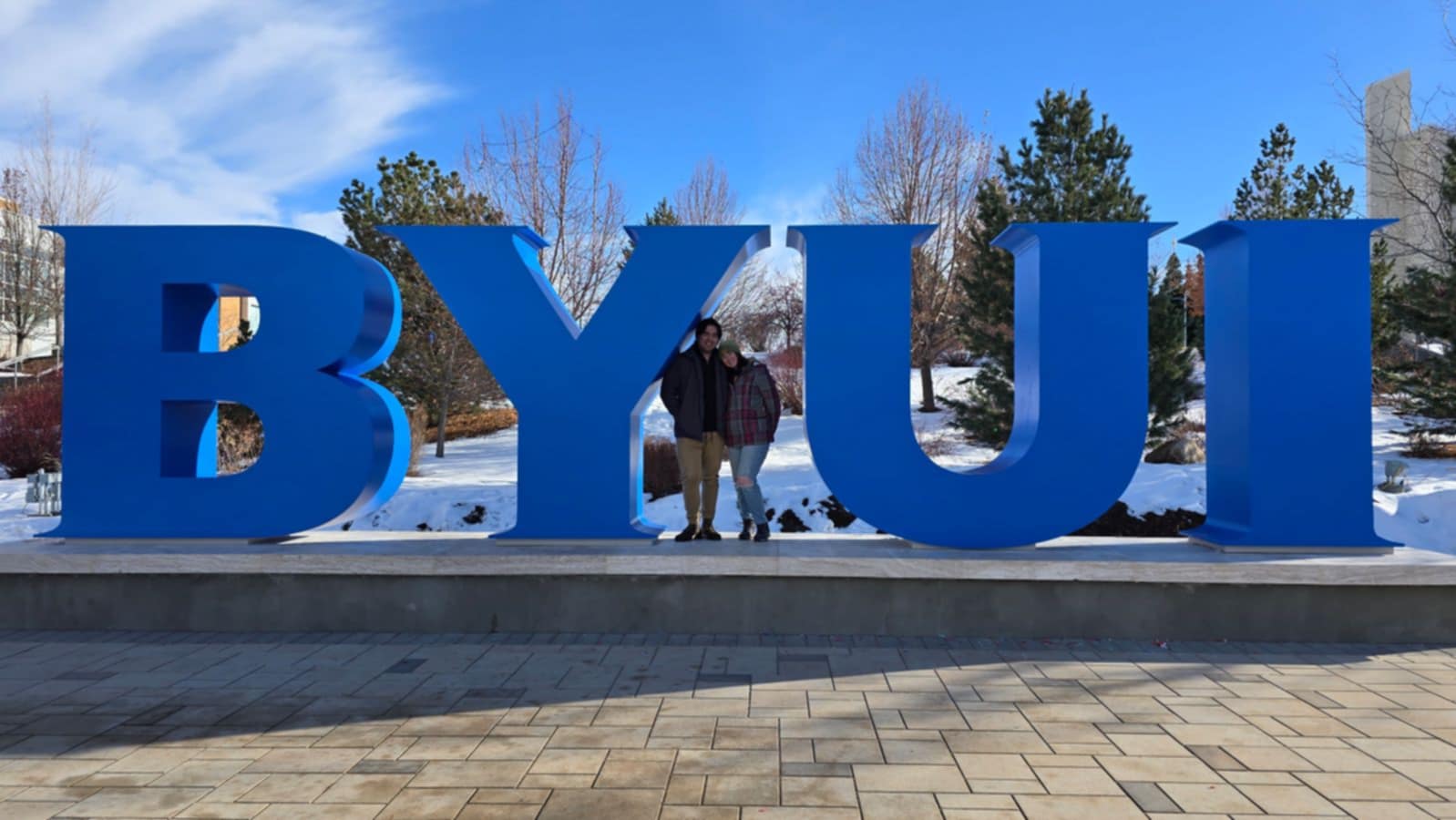 Photo of myself and my wife in front of the BYUI sign